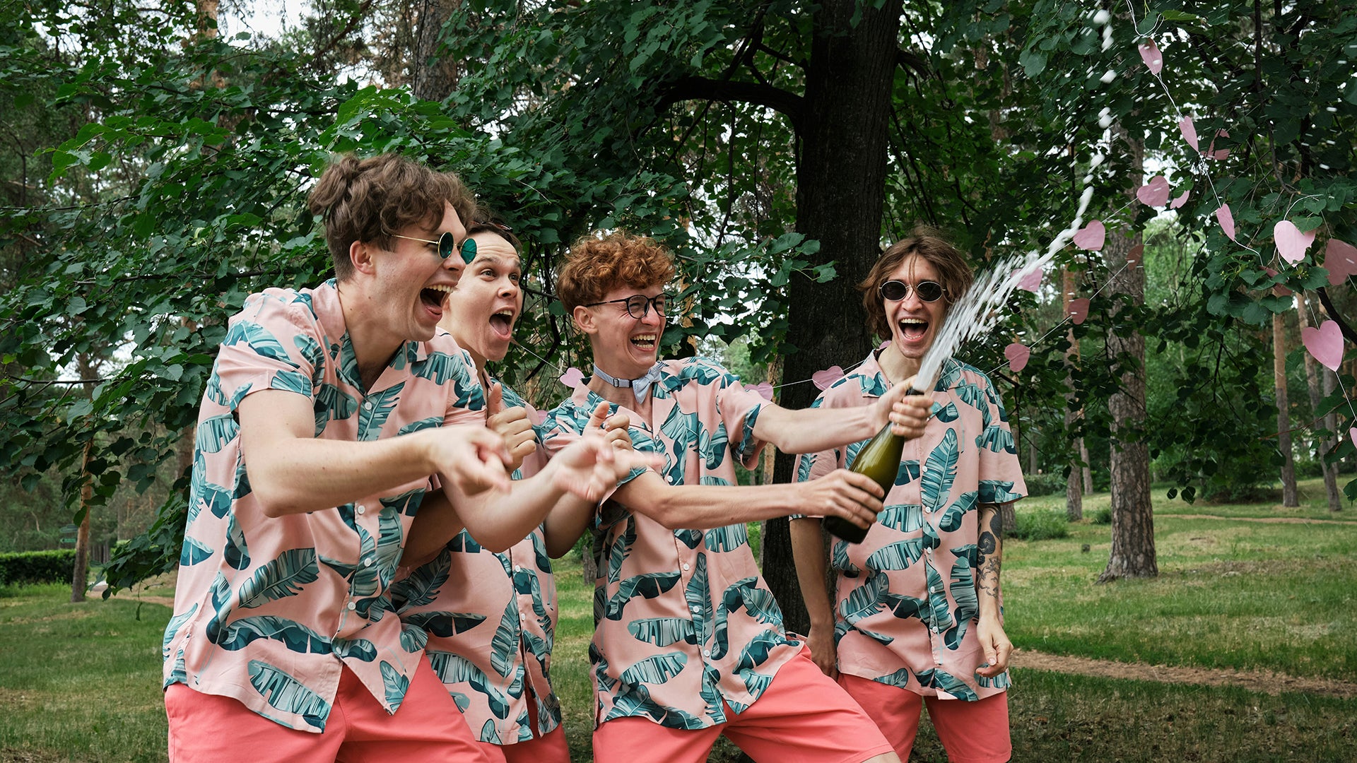 boys popping champagne and having fun