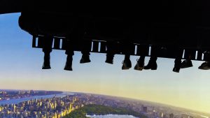 people riding a vr simulator with a view of the city