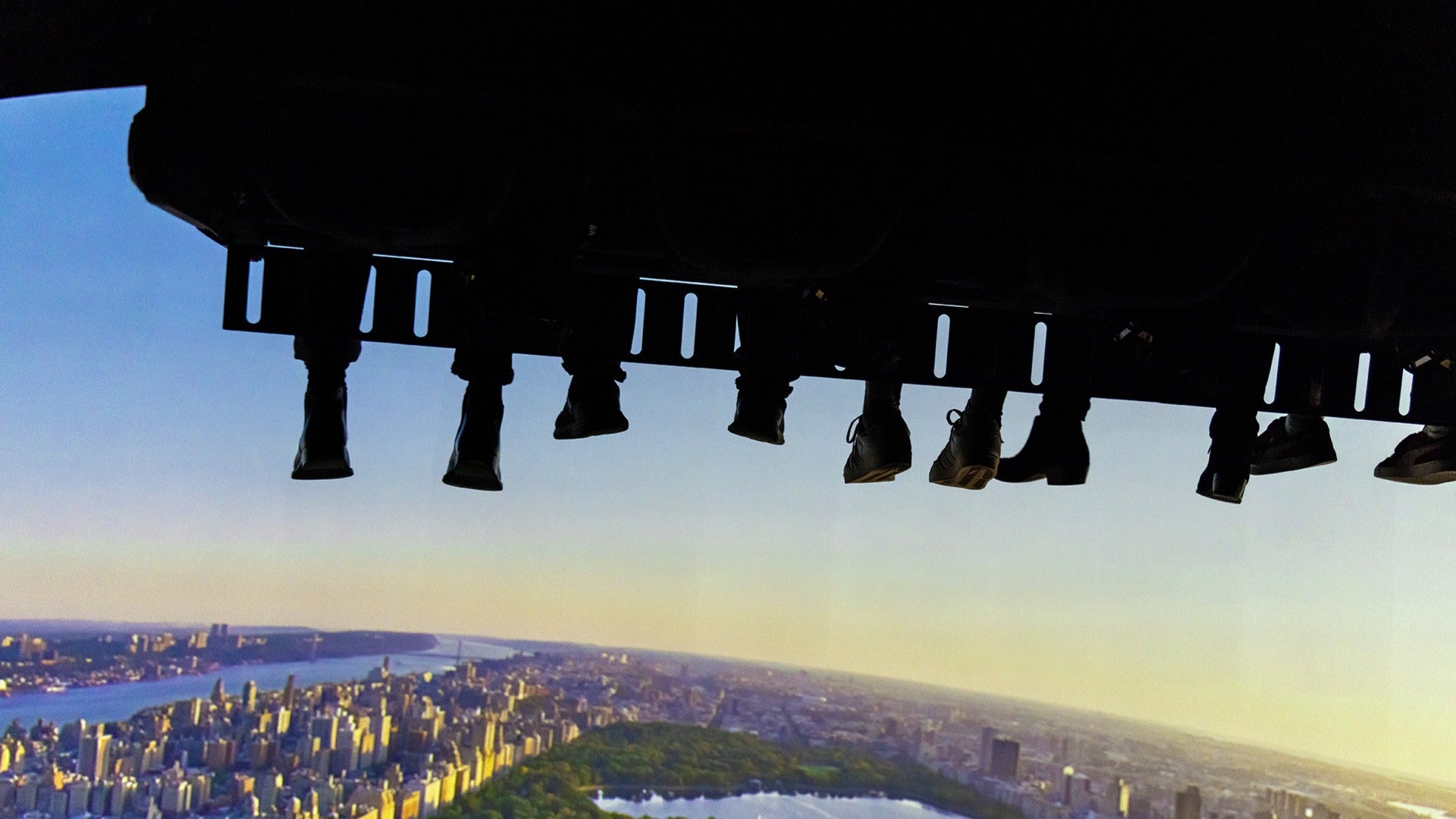 people riding a vr simulator with a view of the city