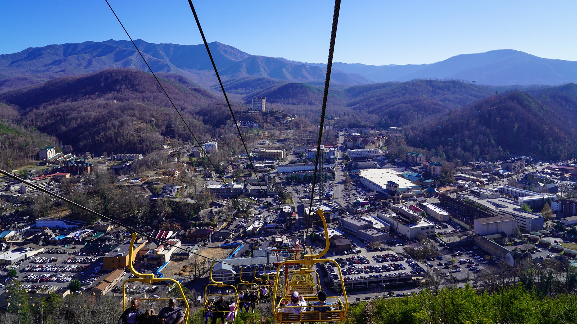 a chairlift showing views of Gatlinburg town below