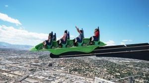 people on an aerial ride with a view of las vegas