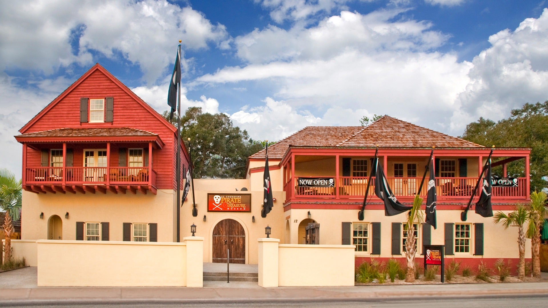 a museum exterior with pirate flags hanging off it