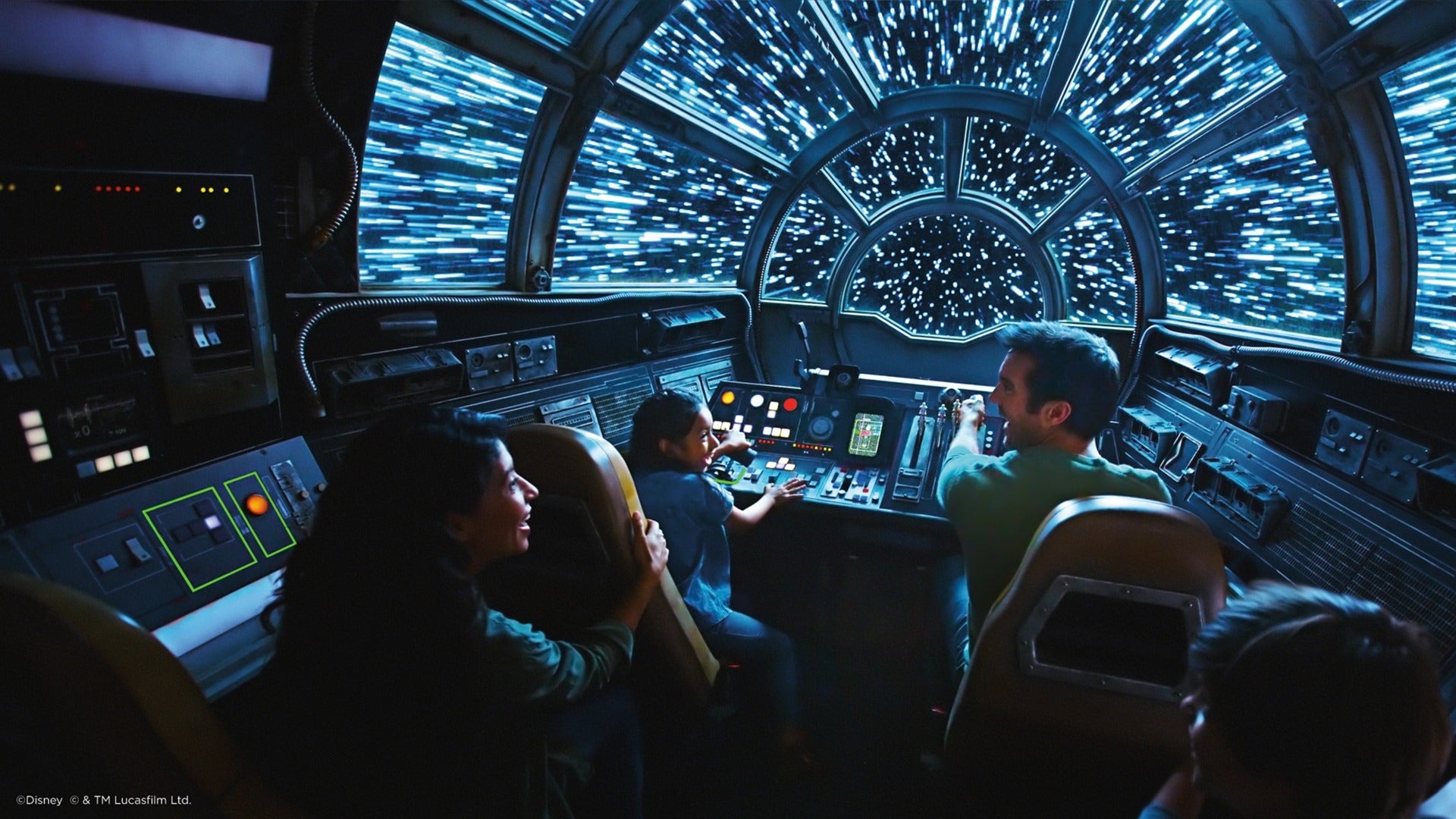a family in an amusement park ride simulating a spaceship with stars