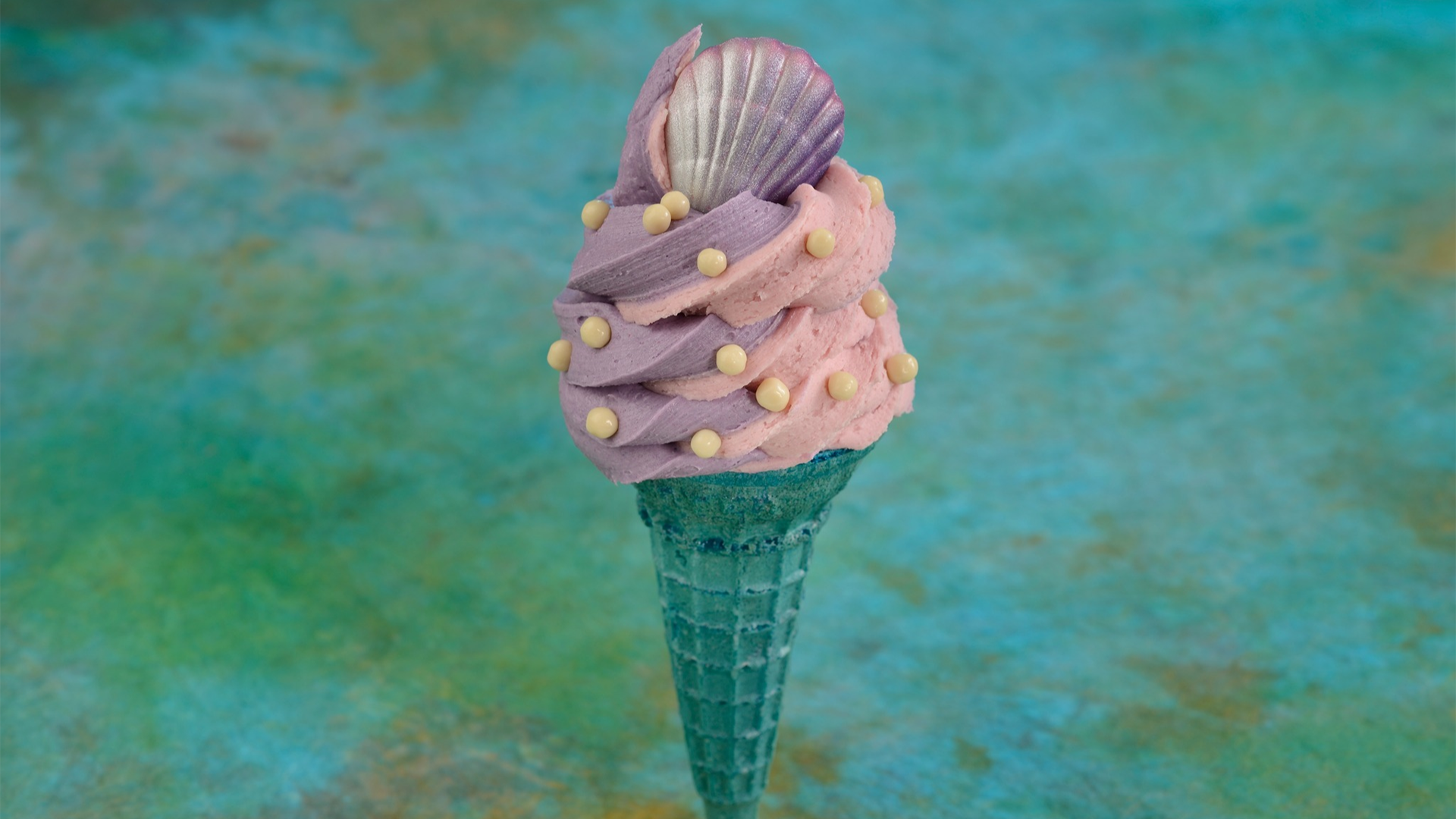 ice cream with different flavors and a shell shaped cookie
