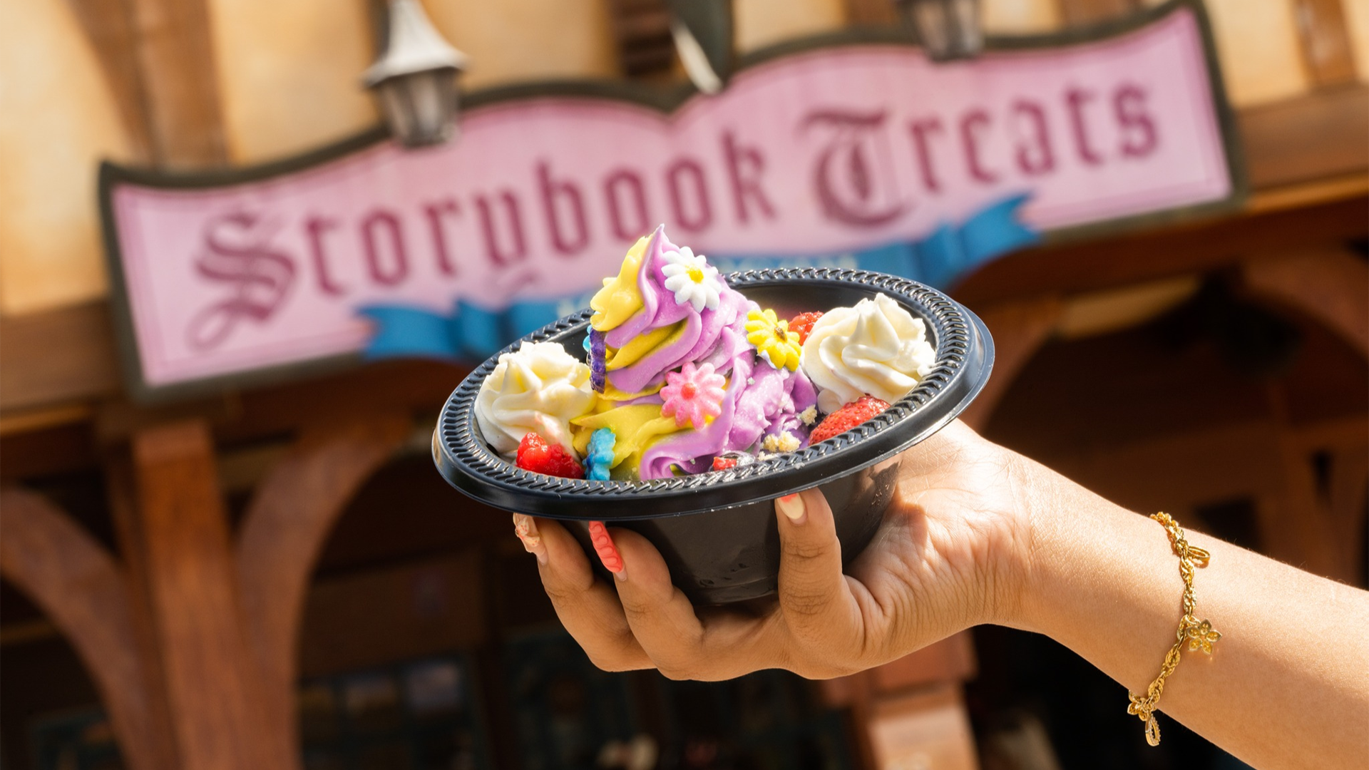 a bowl of ice cream with flowers and a storybook treats signage at the back