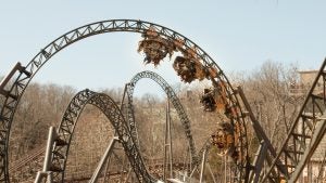 Spinning coaster car on Time Traveler against scenic Ozark background