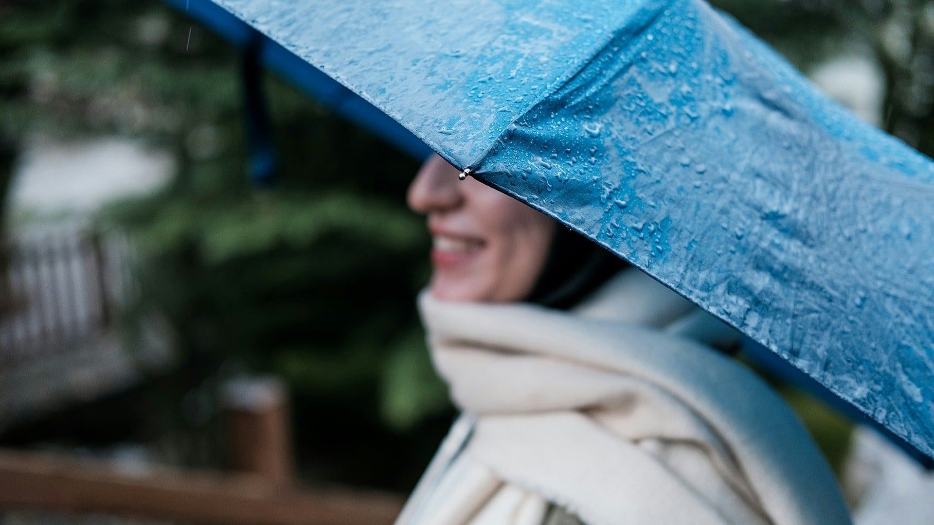 woman holding an umbrella while it's raining