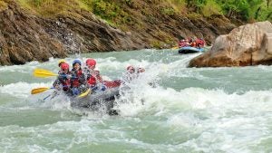group of people going white water rafting