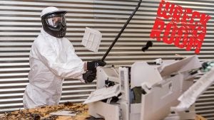 a woman in rage room holding a steel bar