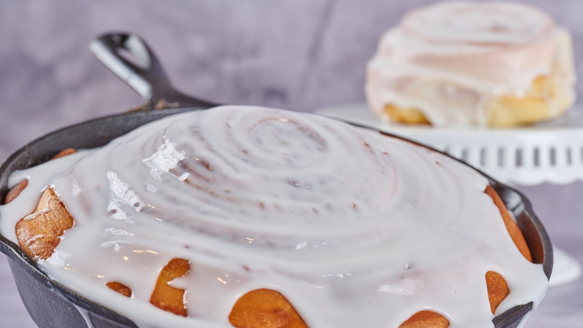 cinnamon bread in a pan with sauce topping