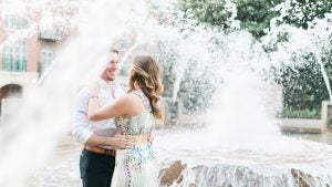 a couple dancing beside the fountain, rainbow row