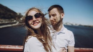 a couple on a cruise with the girl's hair blowing in the wind