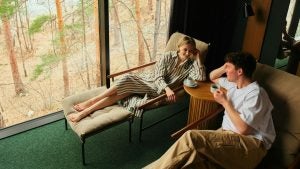 a couple relaxing in a spa wearing a robe and drinking coffee