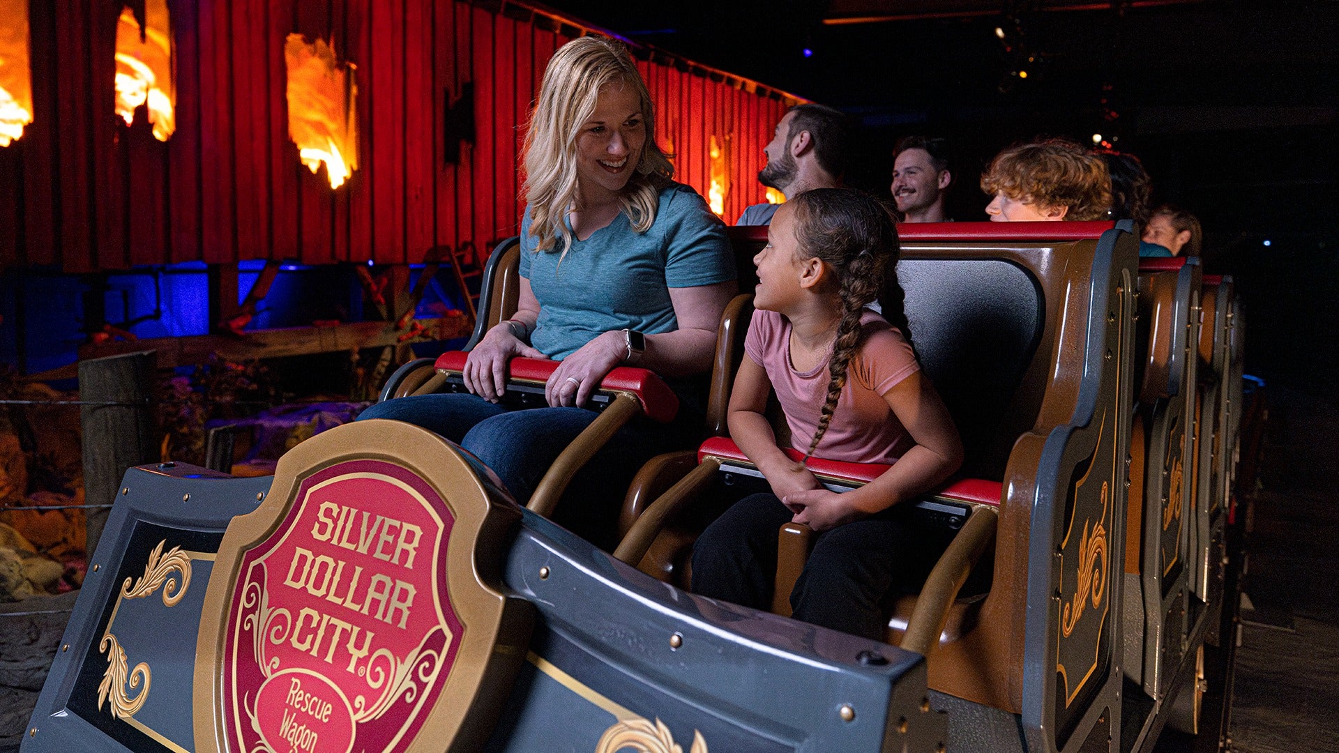 a mother and child riding the front row seat of a silver dollar city ride