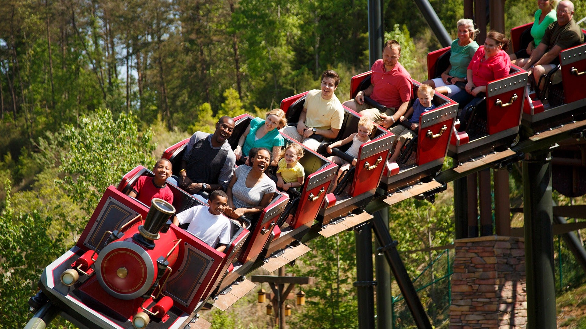 Riders scream and smile as the FireChaser Express roller coaster launches forward at Dollywood