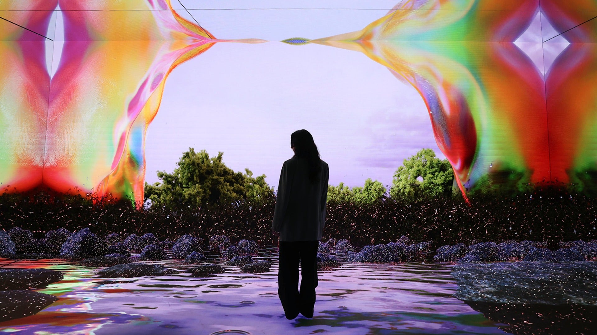 a woman's back turned on a colorful museum exhibit