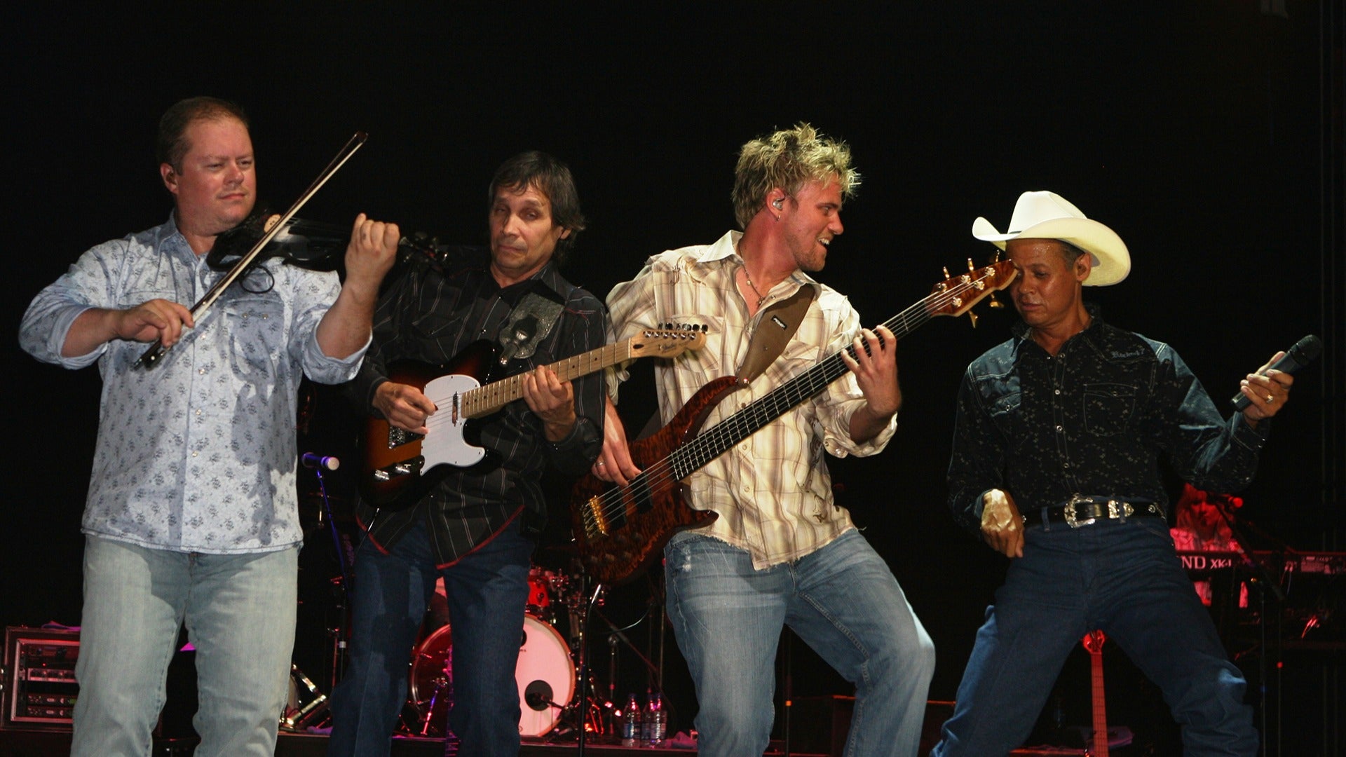 group of performers on stage using instruments