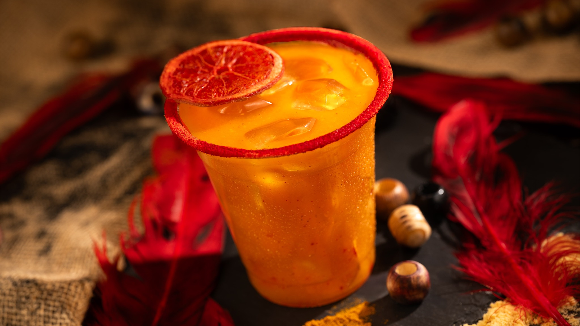 a red rimmed alcoholic drink with garnish