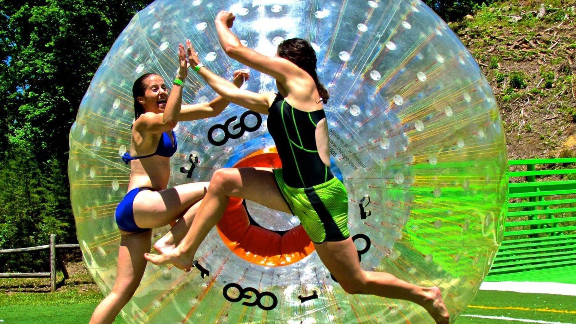 two women playfighting in a zorb at a gravity park