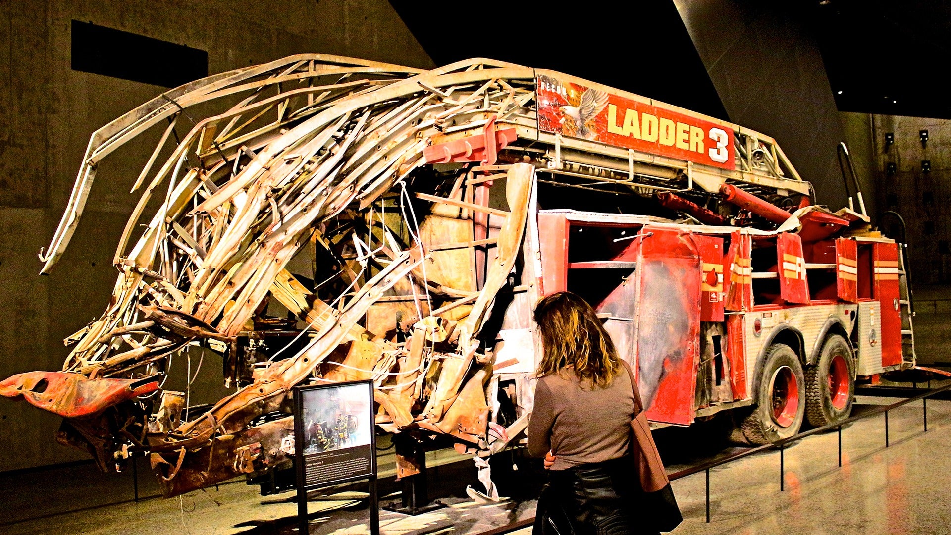 a broken firetruck on display in a museum