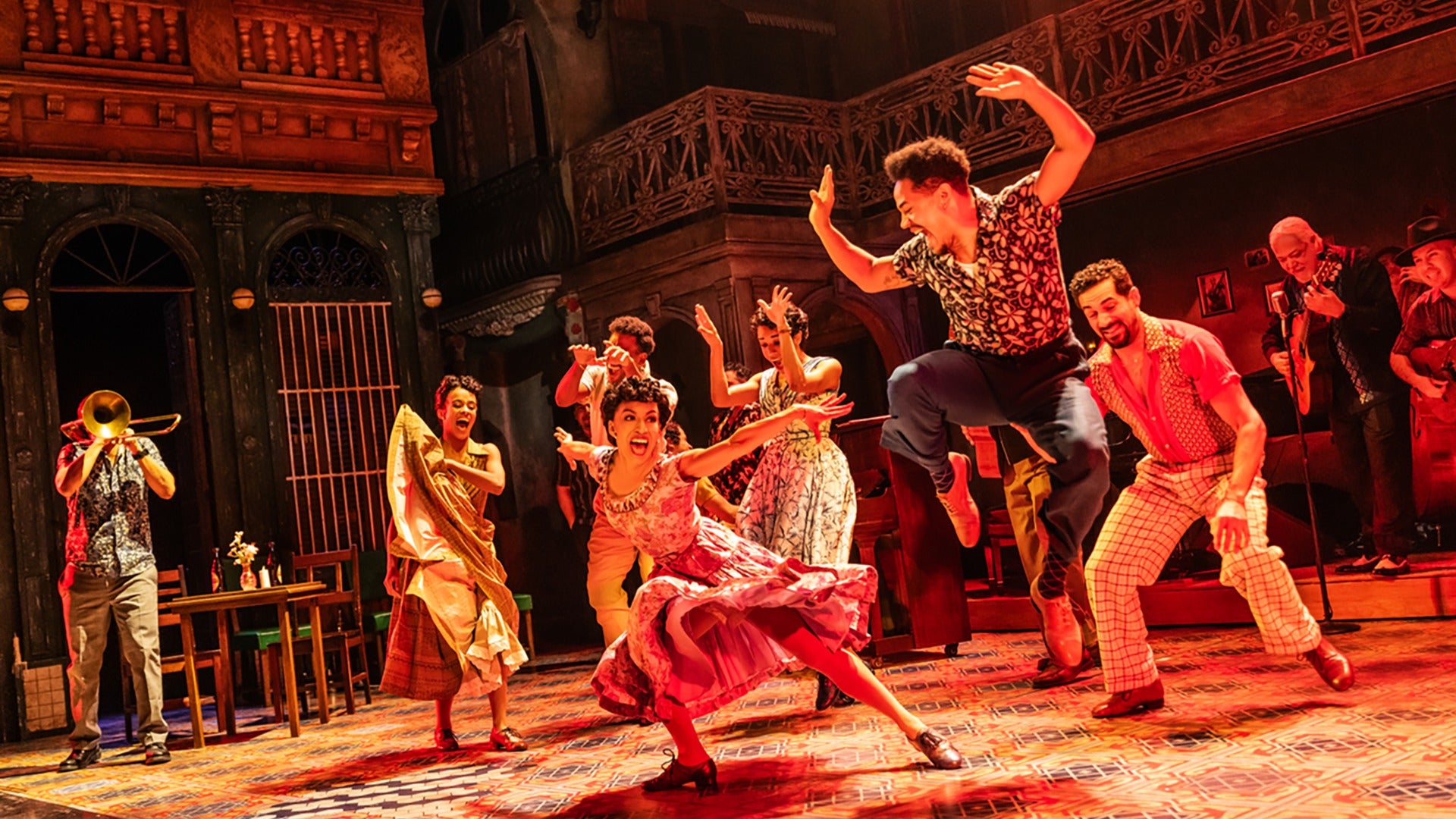 on stage dancers in costumes performing a number