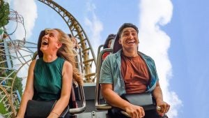 people happily riding a roller coaster