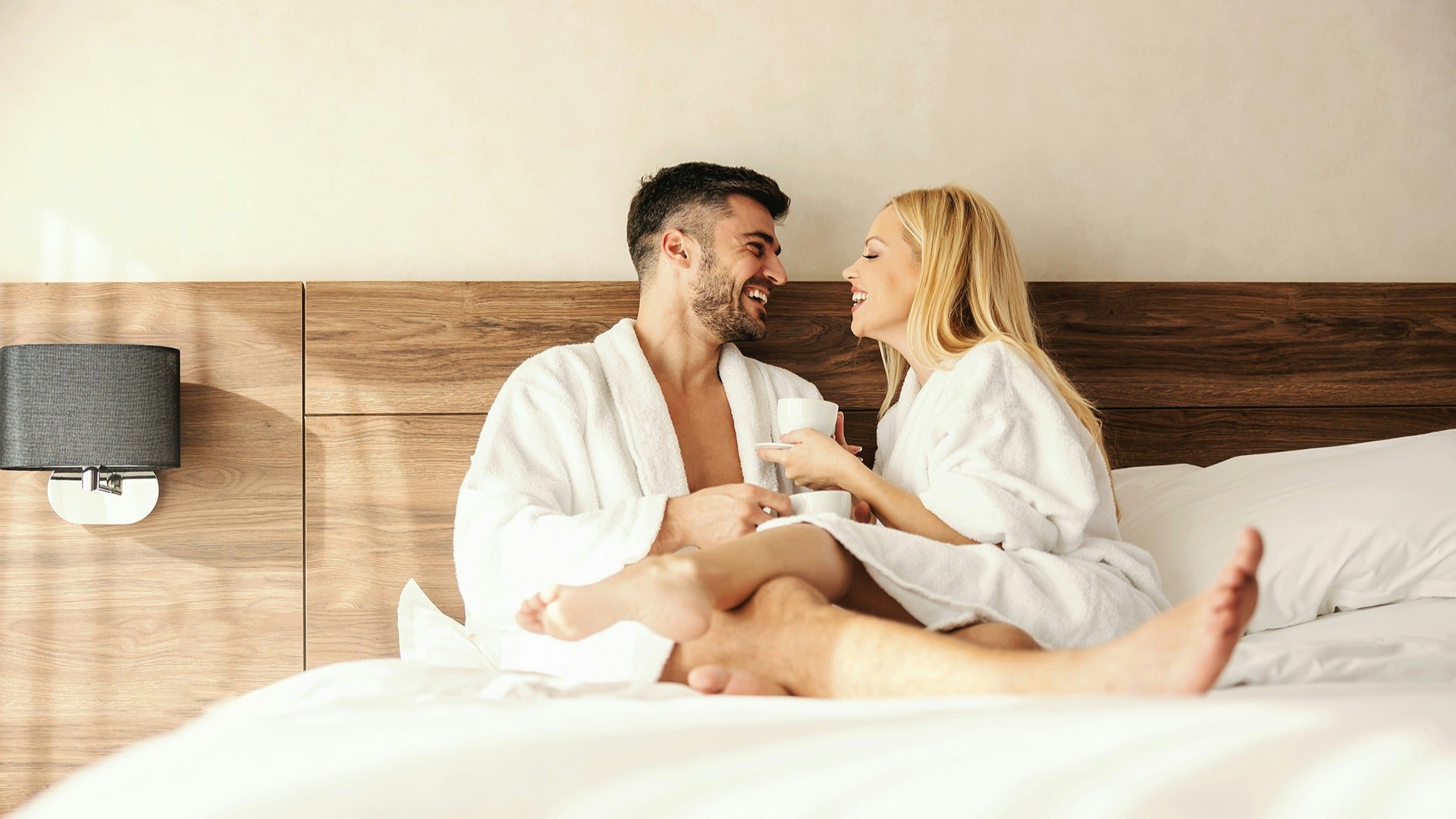 a couple dressed in robes in a hotel