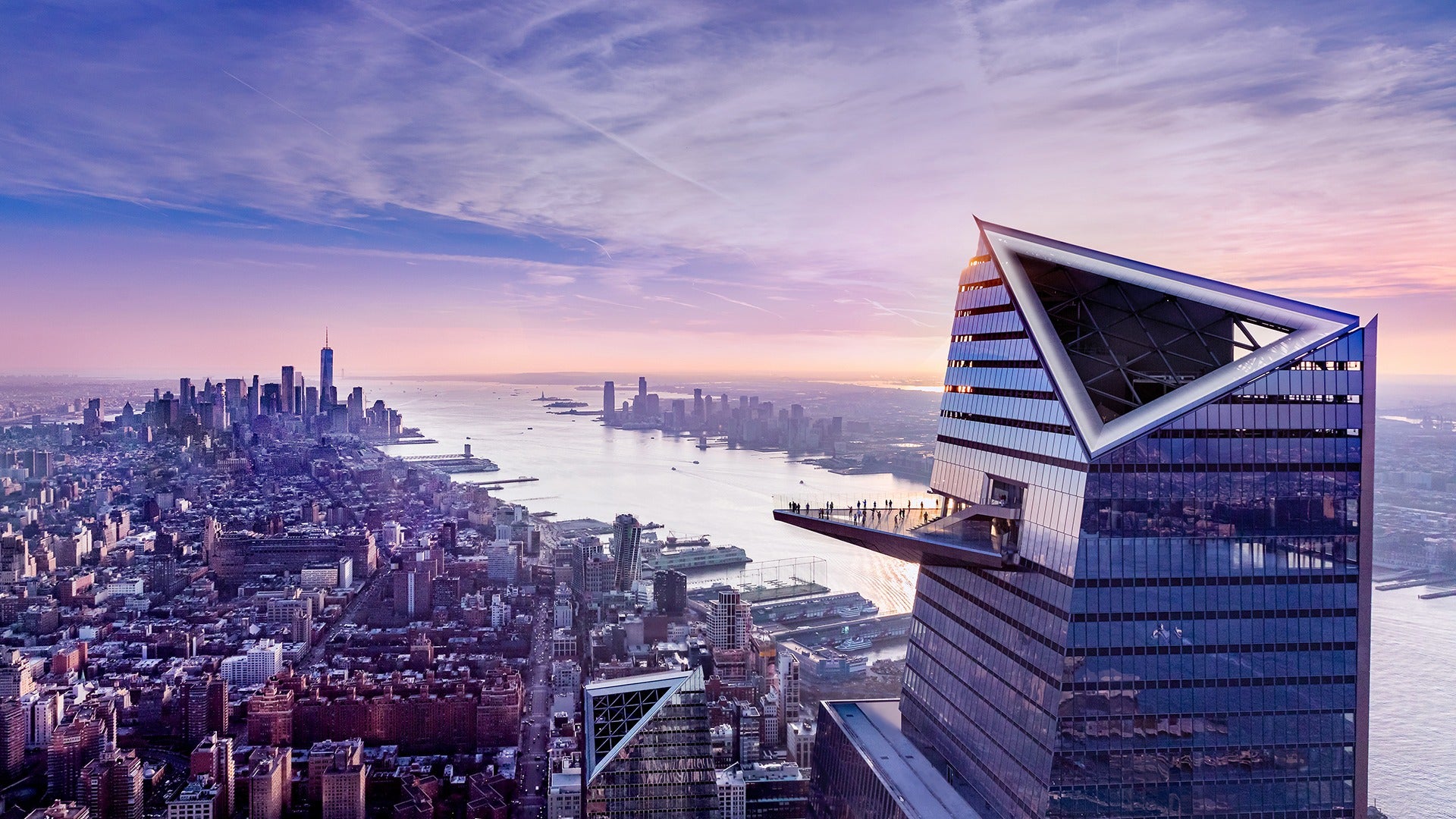 a building edge observation deck with a view of new york city skyline