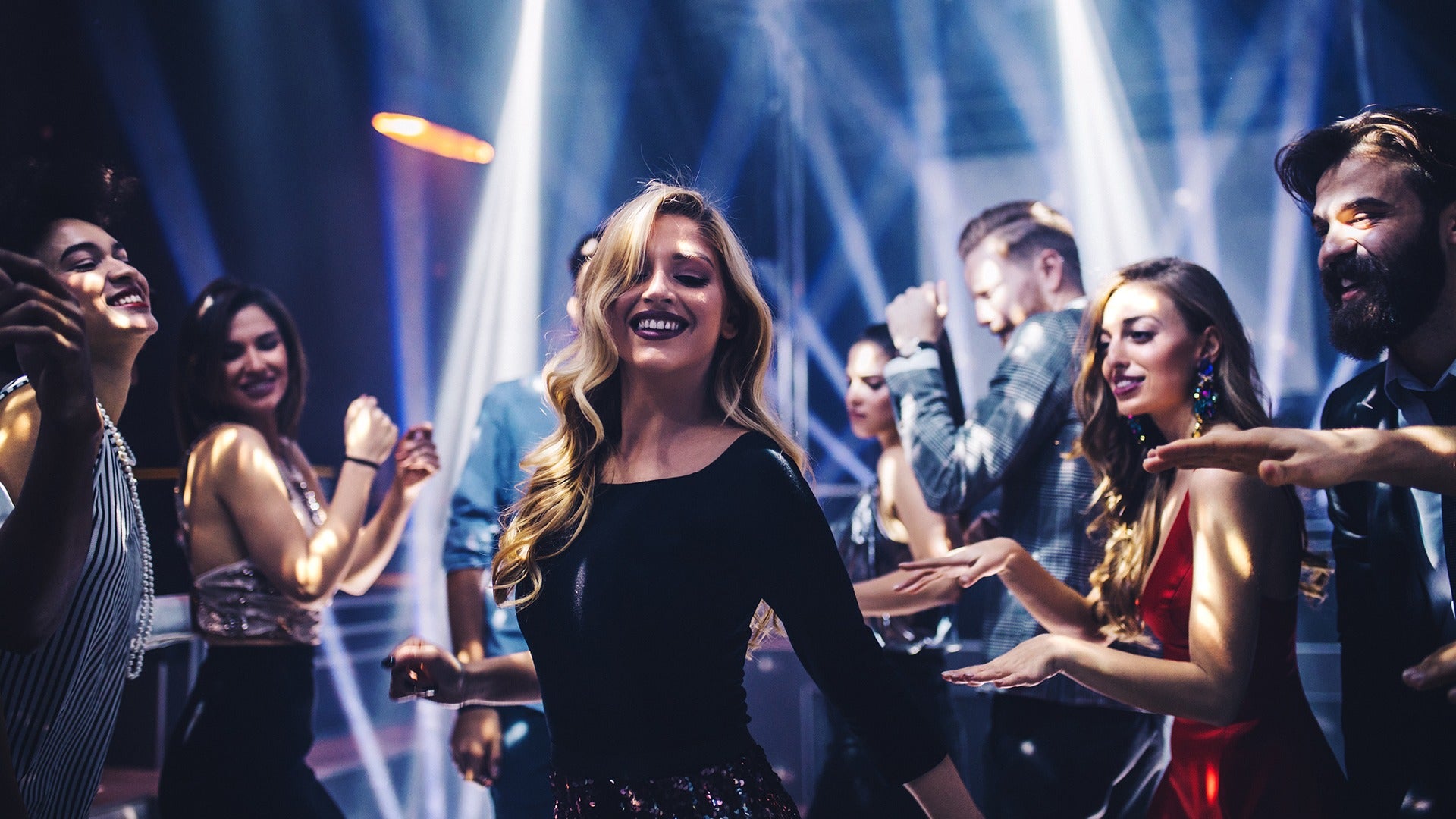 a group of people in a club dancing and having fun