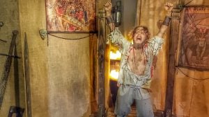 a reimagination of old torture methods, with a man strapped in wooden poles