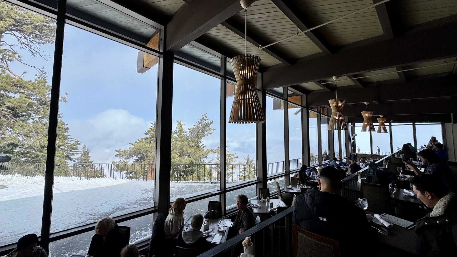 View looking outside over snow covered mountains at the Peaks Restaurant at the Palm Springs Aerial Tramway