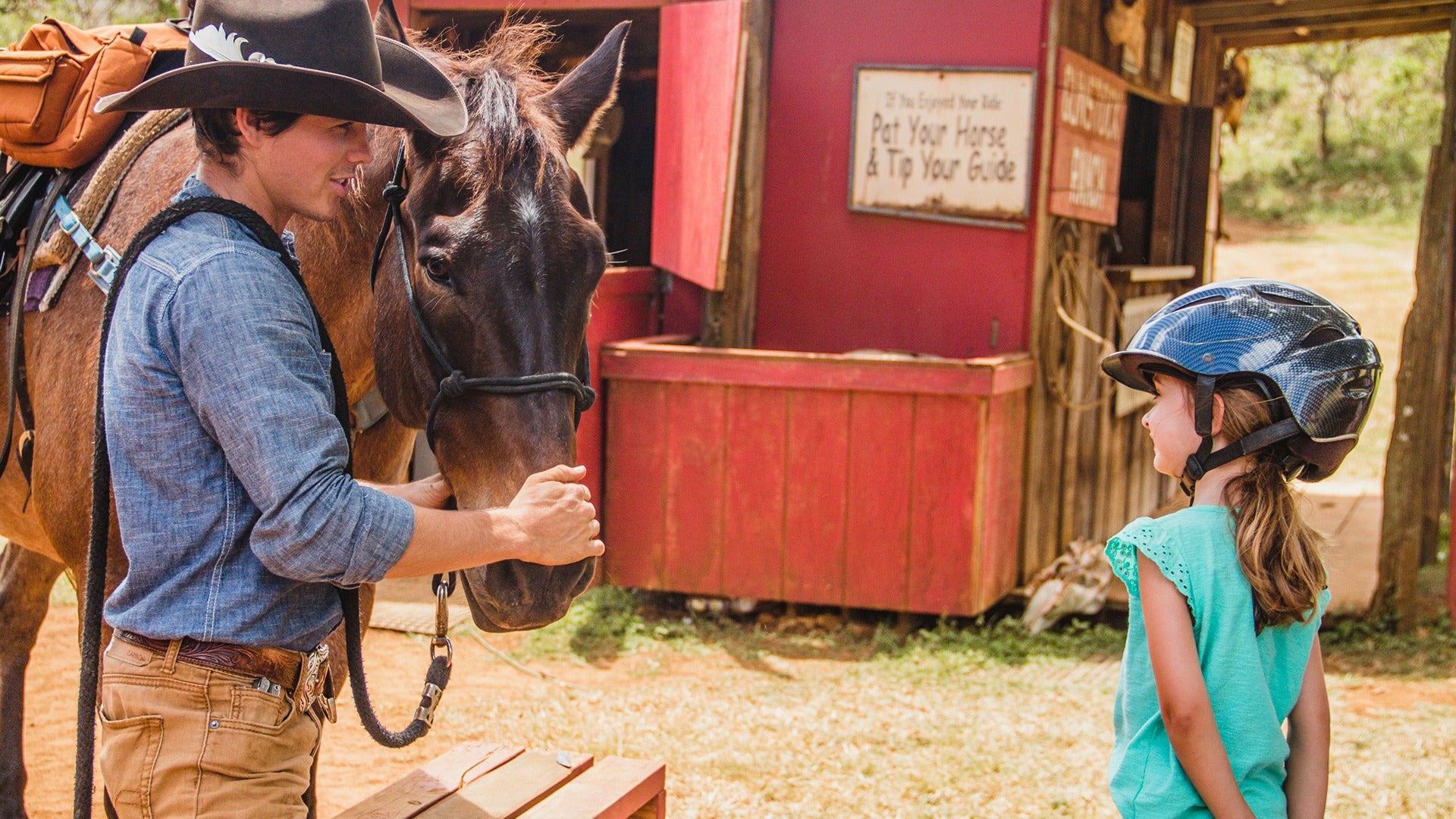 a little girl listening to an instructor briefing about riding a pony