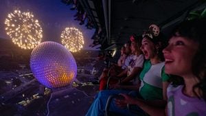group pf people in an interactive theme park ride with a view of walt disney world