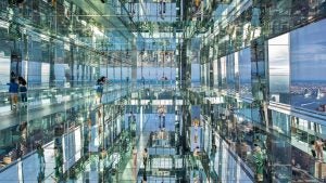 a glass building with people exploring it