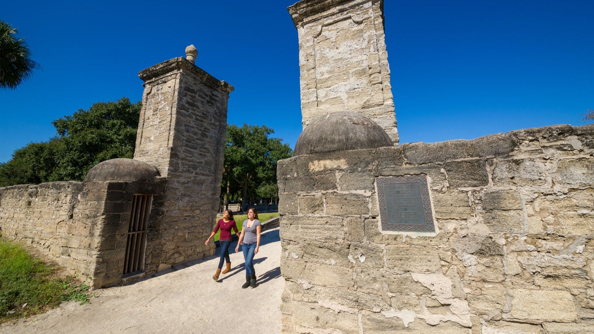 two women passing through the alamo