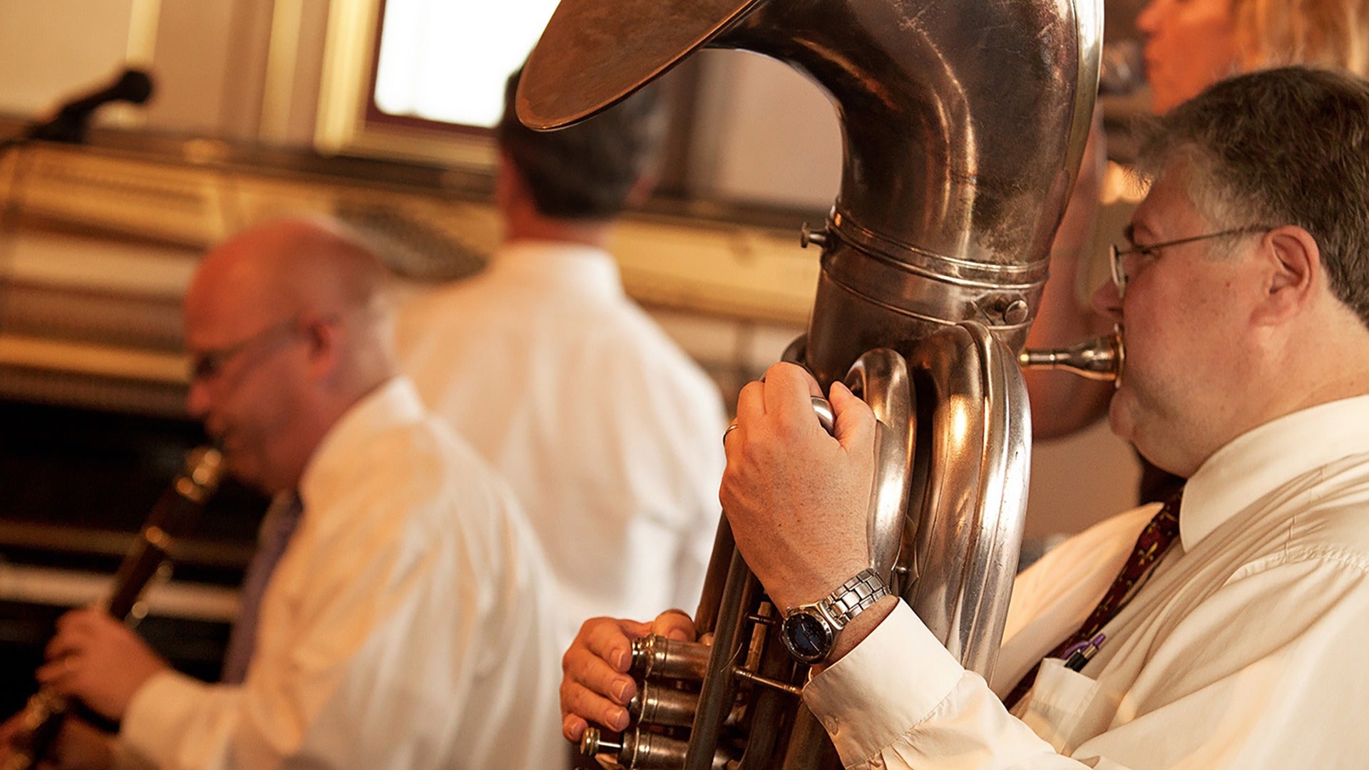 musicians using instruments like a trombone and a flute