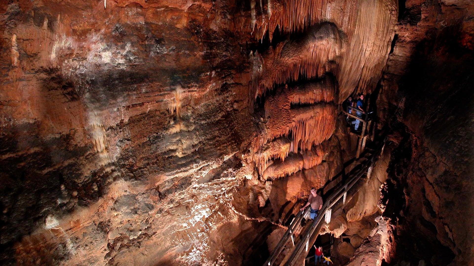 the cathedral part of the talking rocks caverns, with a family walking through it