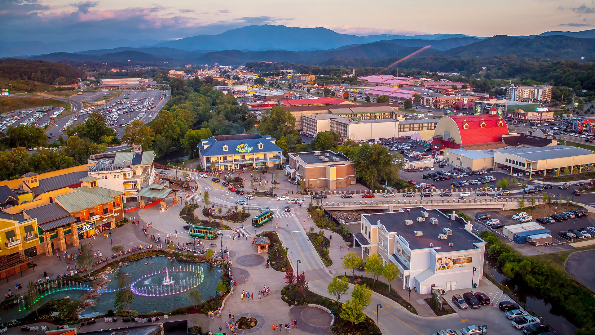 an overview of icon park at pigeon forge, seen with a fountain, streets, cars parked
