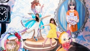 two kids enjoying taking photos in an interactive museum