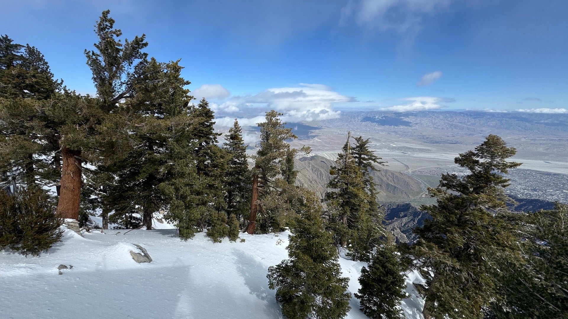View from the summit of the Palm Springs Aerial tramway looking out over desert and snow covered mountains