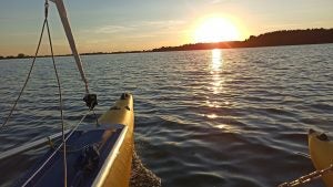a catamaran on the ocean at sunset