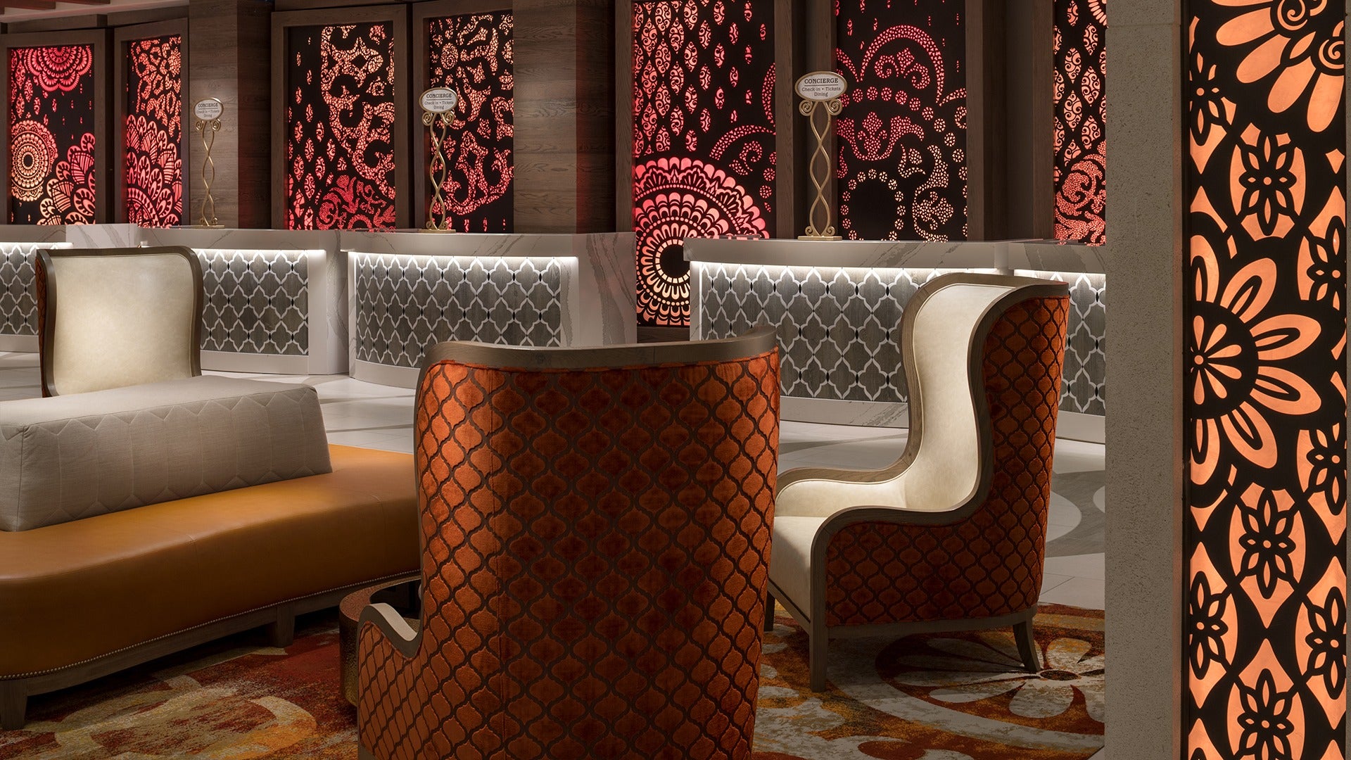 a lobby of a hotel with lighting fixtures and walls