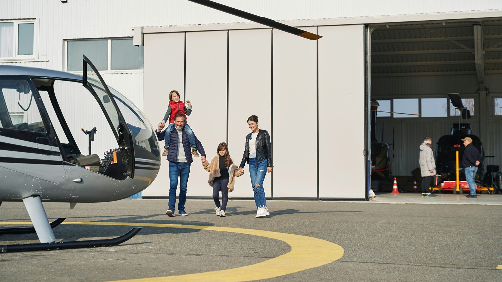 a family about to ride a helicopter in an airport