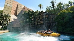 people on a splash ride with water features and trees