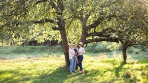 a family posing in front of a tree