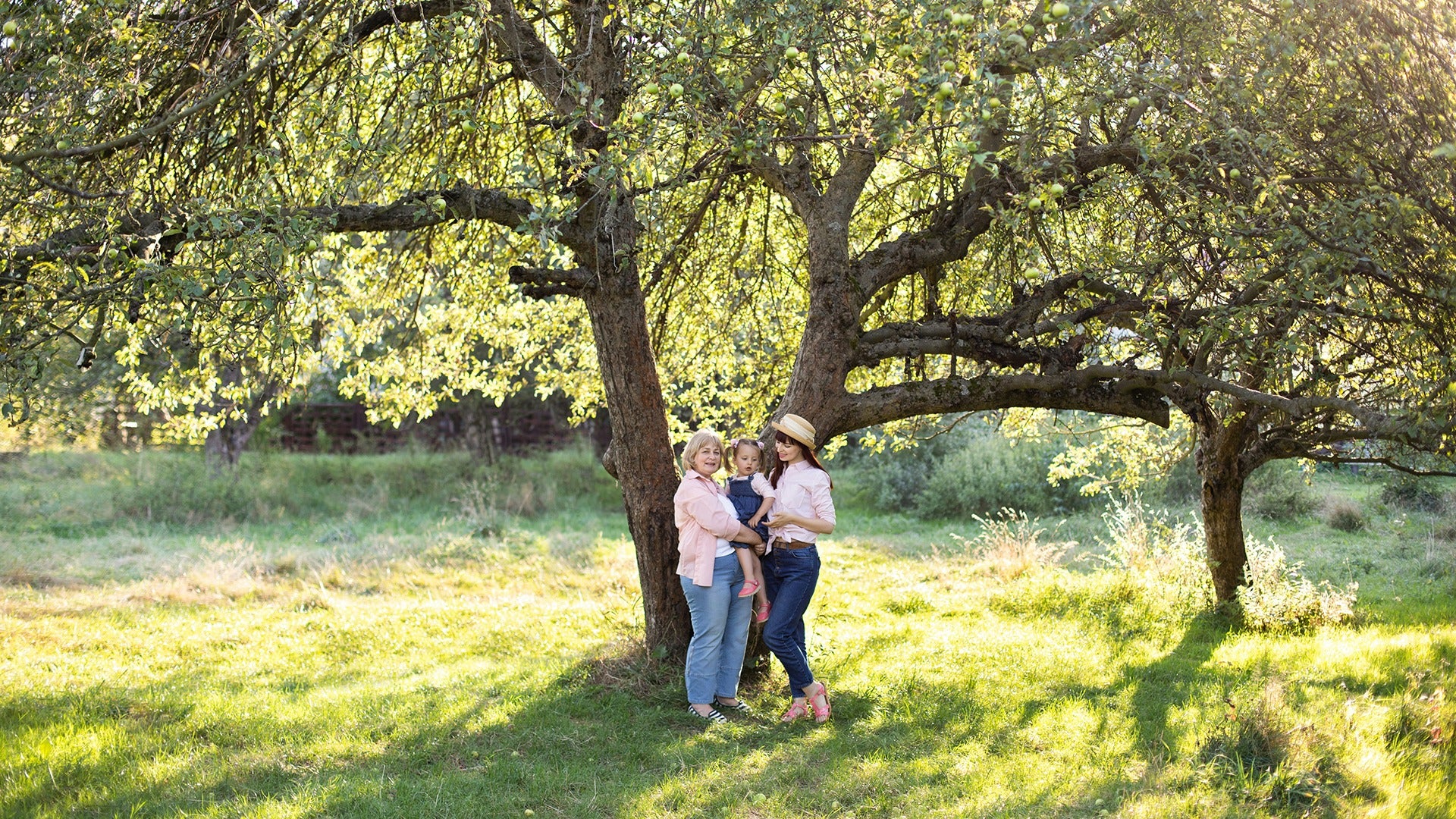 a family posing in front of a tree