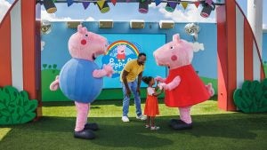 a father and daughter meeting peppa pig characters