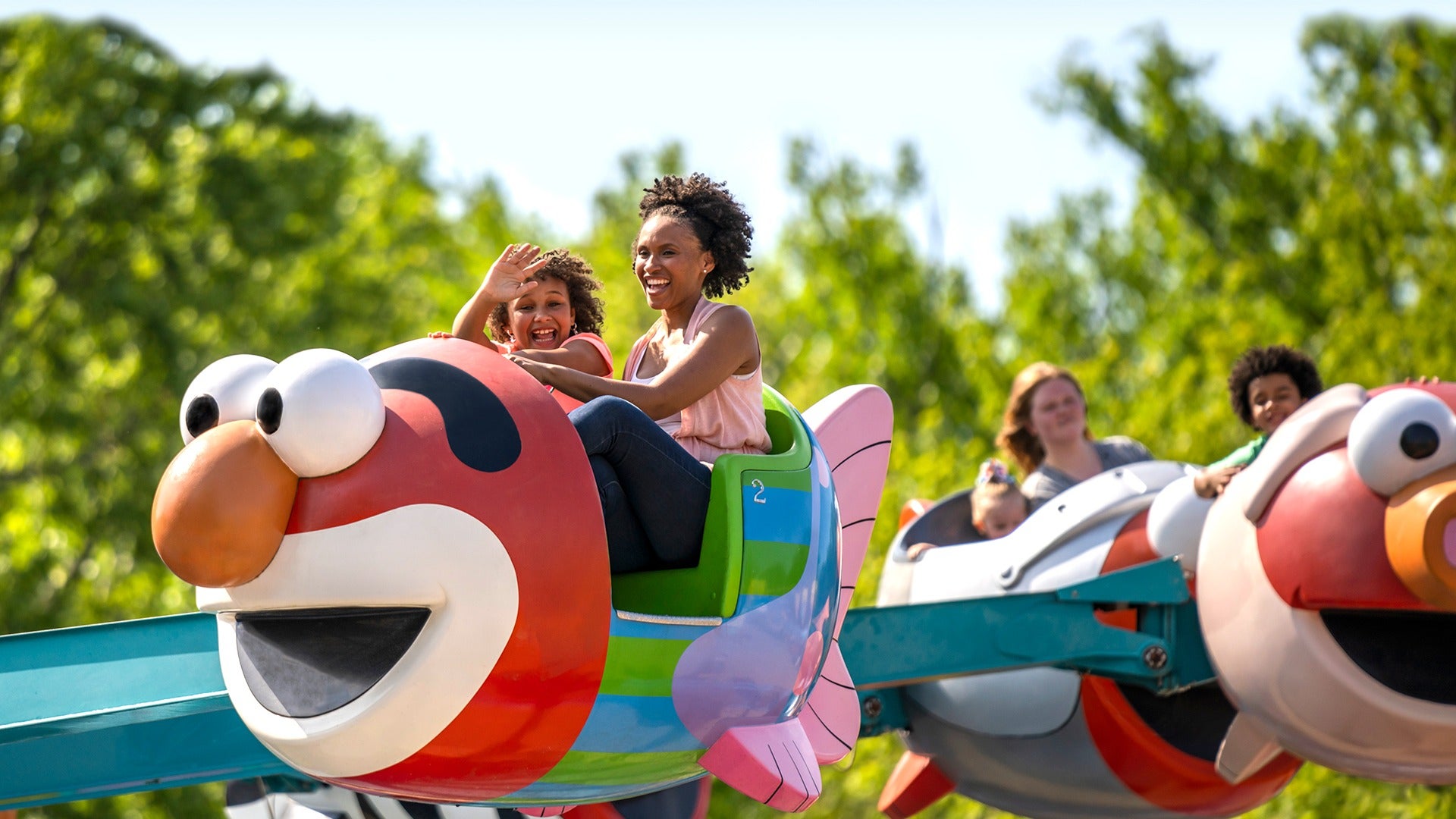 a mother and child riding a theme park ride