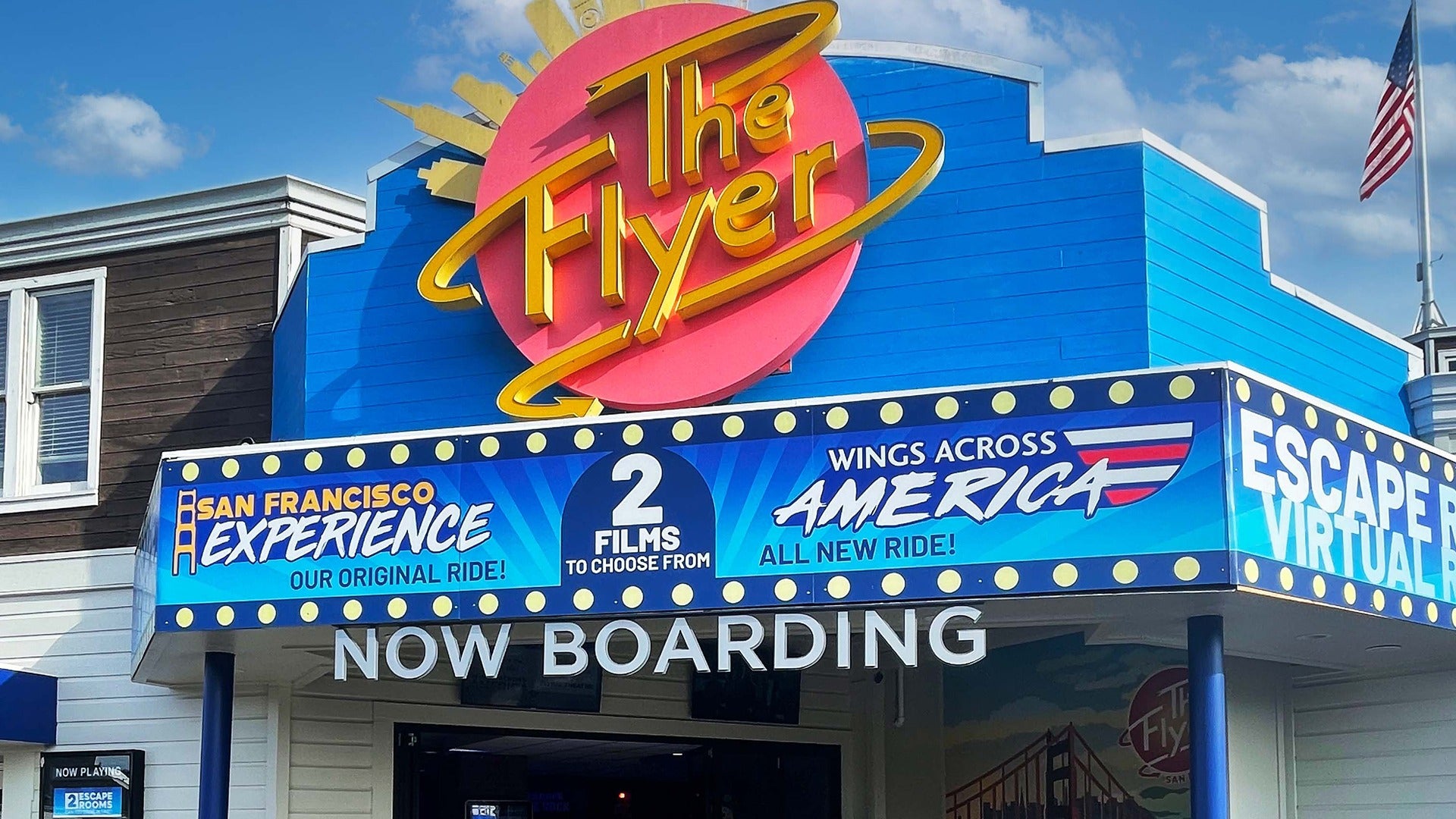 a signage of an attraction experience, with the door and american flag at the back