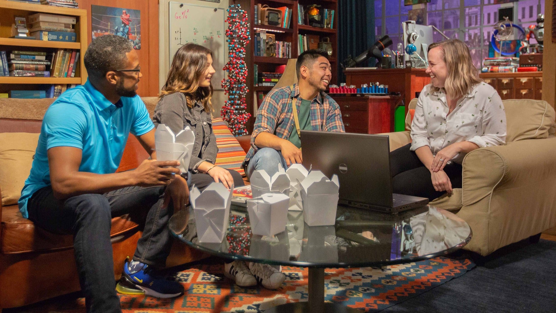 a group of friends bonding in a living room eating chinese takeout food